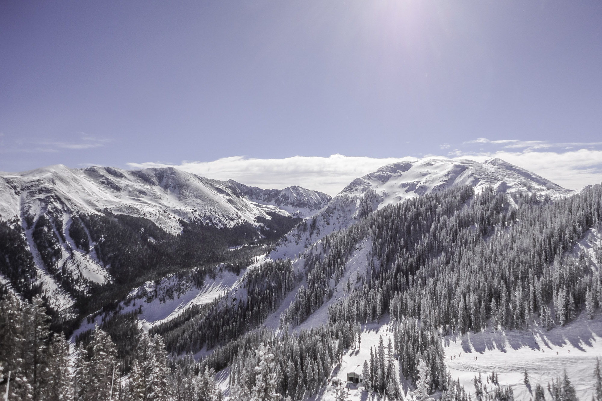 A sunny winter view of Kachina peak. The view is from near the top of Chair #2 at Taos Ski Valley. Looking at Kachina Peak on the right, and Wheeler Peak on the left. Taken before the Kachina Peak Lift was installed, the round peak is pristine on on a beautiful bluebird morning. Photo by Andrew Gatewood.